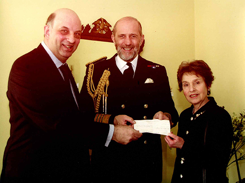 Sheila Diamond with husband Dr Alan Diamond, presenting a cheque to a naval charity to the First Sea Lord in his London residence.